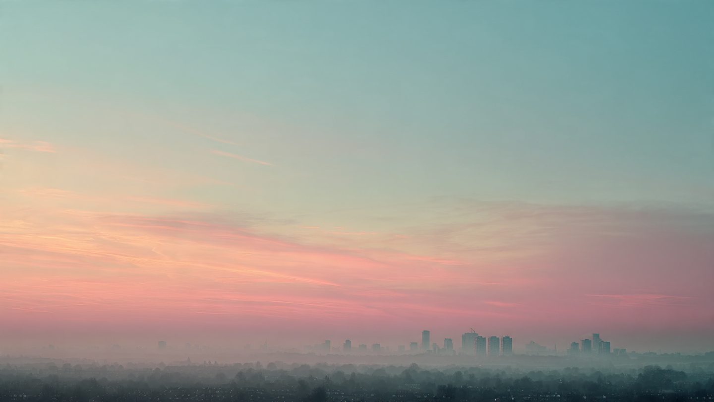 Hidden viewpoints in London at sunrise with a soft pastel sky and distant skyline fading through morning mist, capturing a serene secret viewpoint and quiet elevated skyline outlook across London.