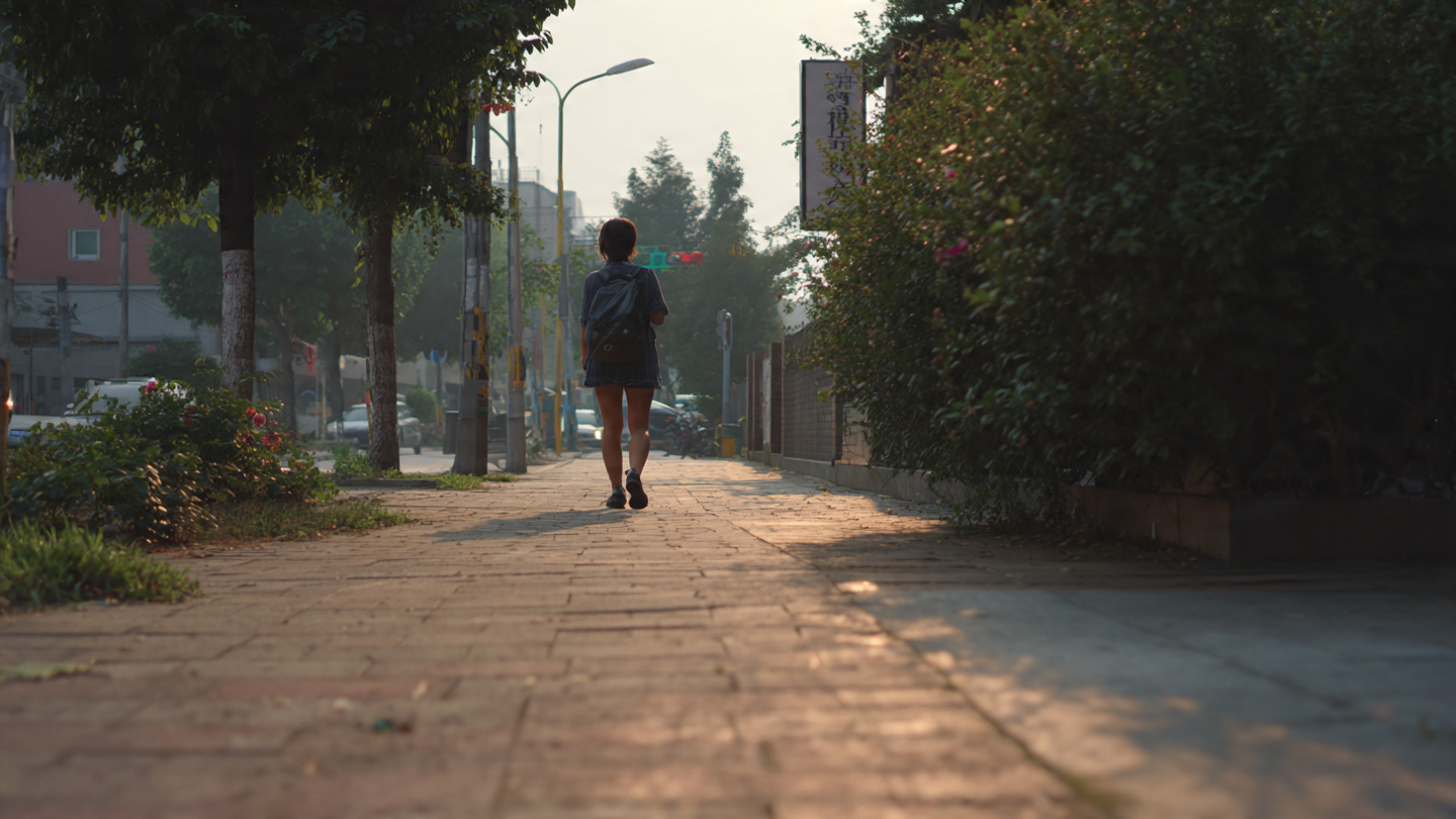Traveler walking calmly along a quiet sidewalk in soft morning light, representing one of the subtle secret places in London where hidden streets and peaceful local areas support slow and reflective city exploration.