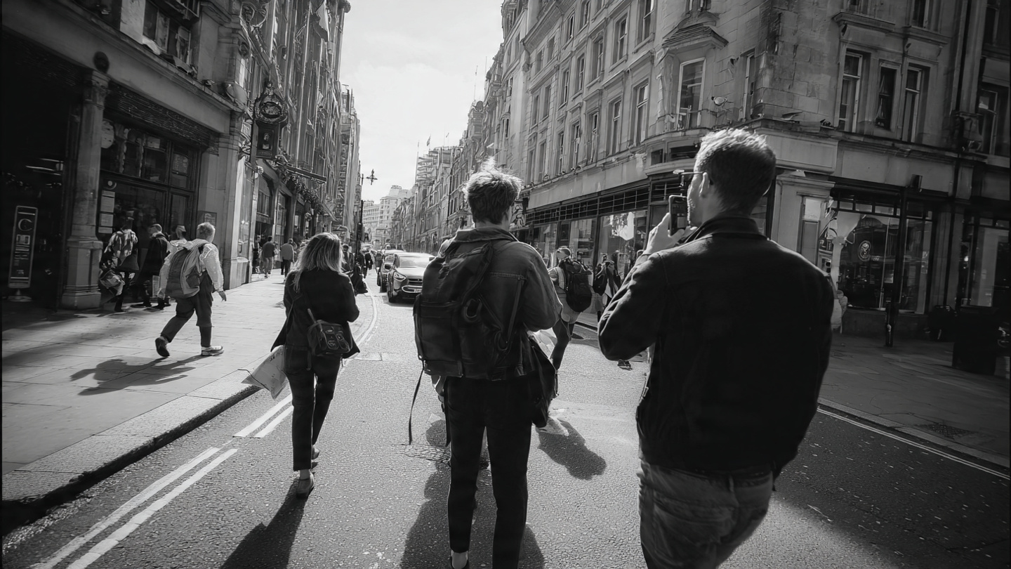 People walking along a busy street in central London, capturing everyday city life and things to do near London city center with nearby walkable experiences.