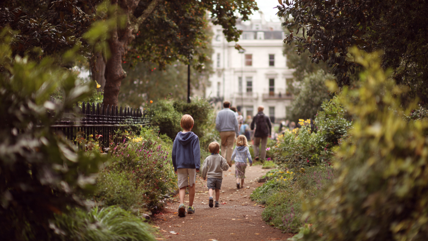 Family walking along a peaceful garden path near Hyde Park, showing family friendly things to do near Hyde Park and relaxed outdoor activities close to the park.