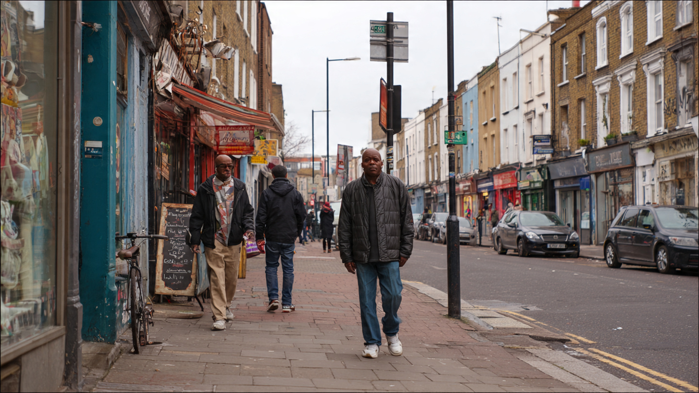 Everyday street life in one of the underrated neighborhoods in London, showing local shops and residents walking through an authentic, lesser-known London district beyond major tourist areas