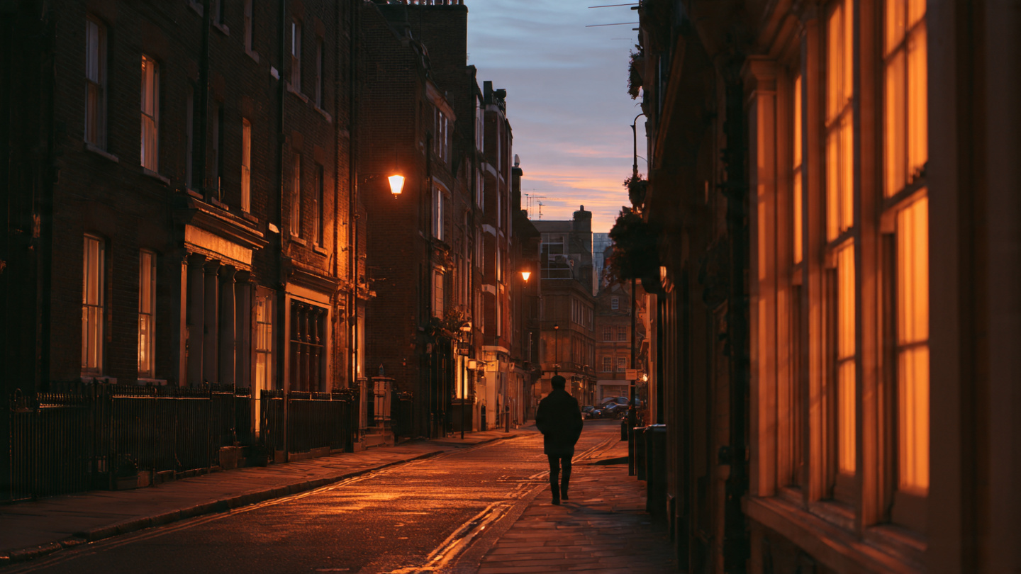 Evening street scene in one of the underrated neighborhoods in London, showing quiet residential buildings and warm lights that reflect authentic, lesser-known London areas beyond busy tourist districts