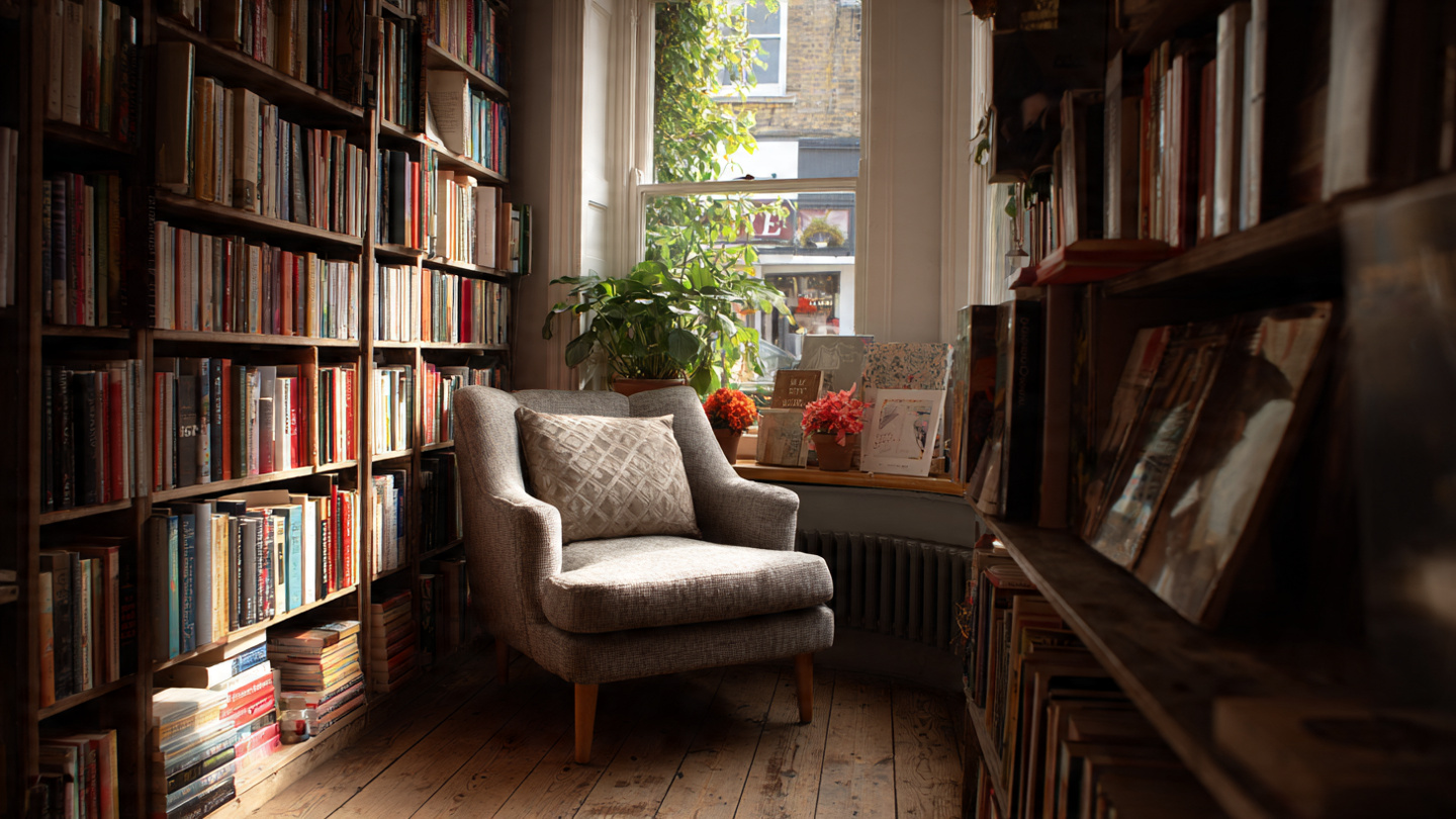 Hidden bookshops in London interior with cozy reading chair, quiet independent bookstore space filled with books and natural light.