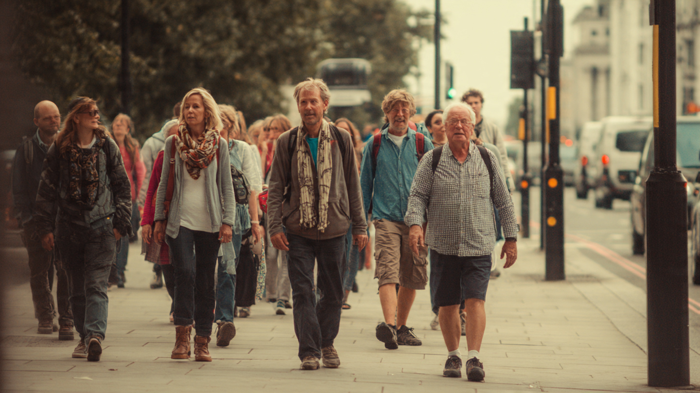 Group of travelers walking comfortably through London streets, showing who a London walking itinerary is best suited for.