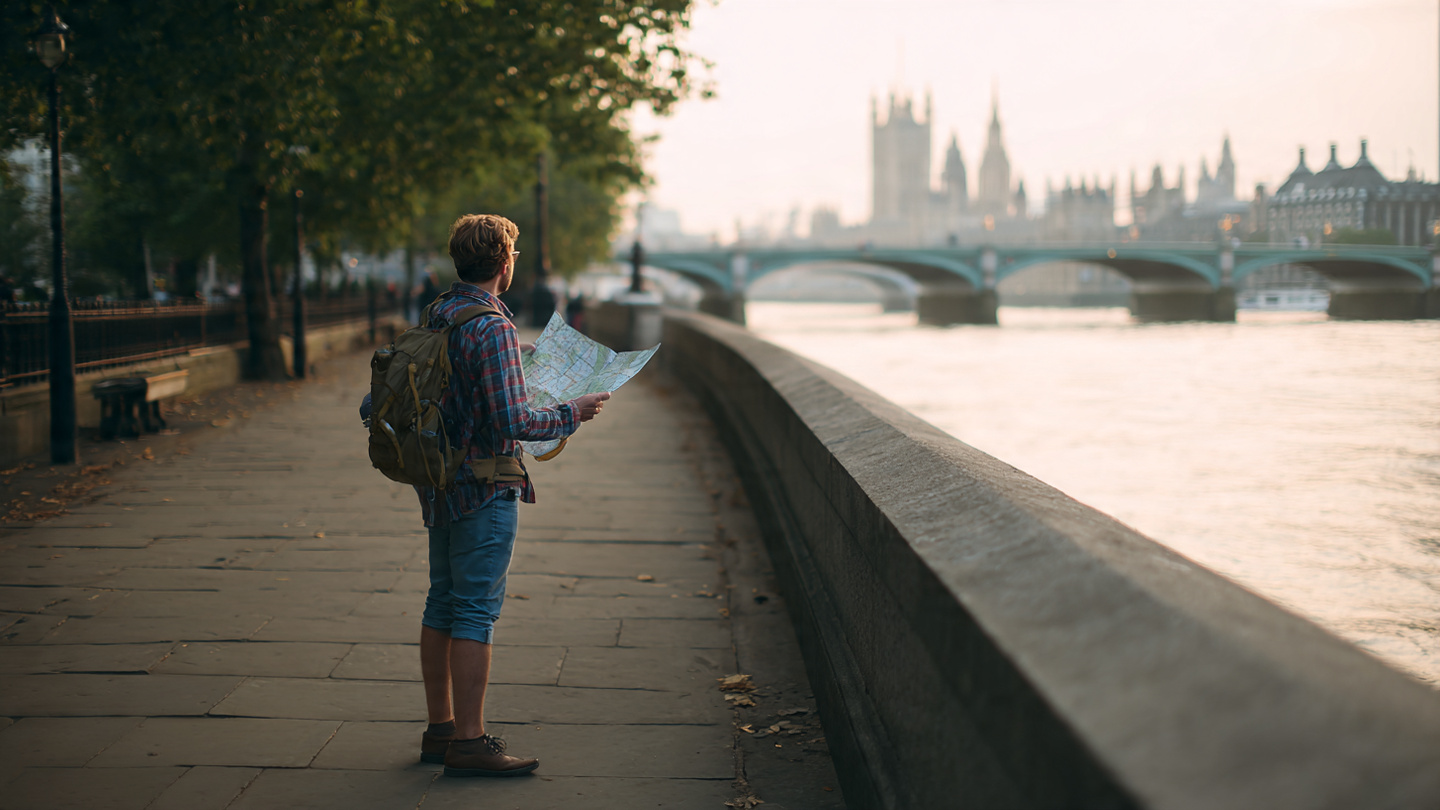 Scenic walks along the River Thames in London with a traveler checking a map near Westminster and riverside views