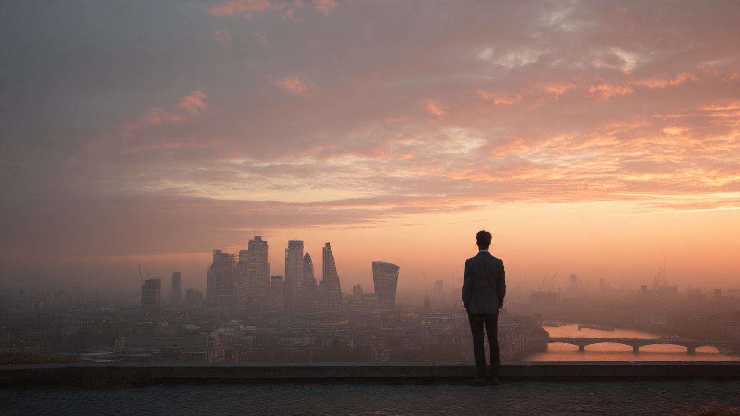 Best sunset viewpoints in London featuring a man overlooking the skyline from an elevated terrace at golden hour with the River Thames in the distance.