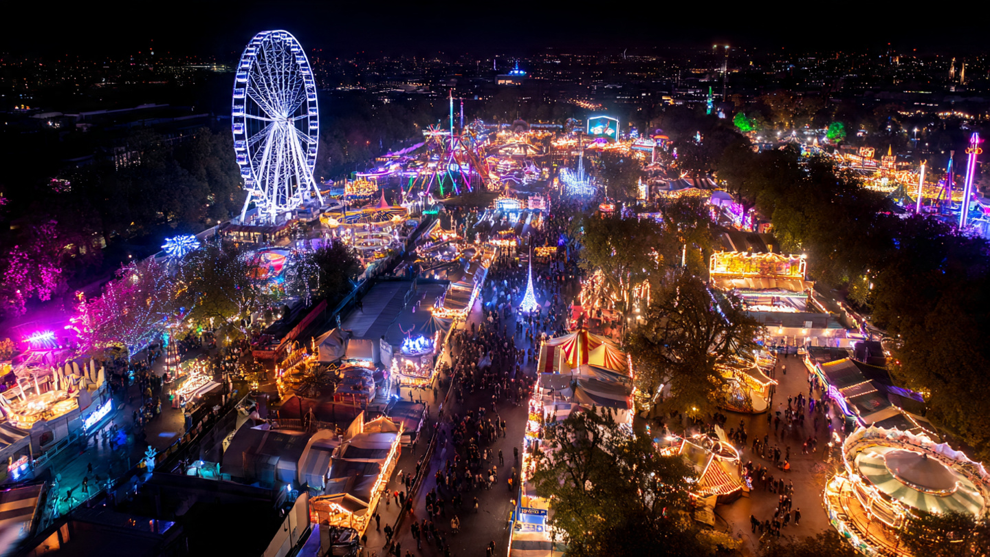 Aerial night view of Winter Wonderland showing the scale of christmas markets in london with rides and bright festive lights